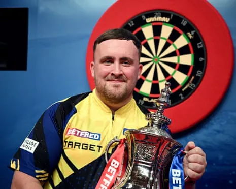 Luke Littler poses for a photo with the 2026 Betfred World Matchplay trophy after his victory against Gerwyn Price.